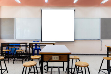 Projector screen canvas in modern conference room with big windows. Side view.Empty classroom or presentation room interior with desks