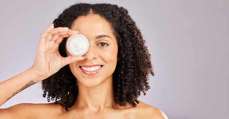 Face, skincare and black woman with cream container in studio isolated on a gray background....