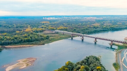 Ufa, Russia. Railway bridge across the Belaya River. The train follows the bridge, Aerial View