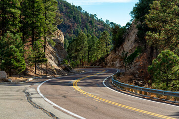 Hidden road in the mountains of arizona in the wild west with yellow and white lines on asphalt...