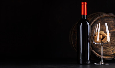 Fototapeta na wymiar Red wine bottle, barrel and wine glass with corks