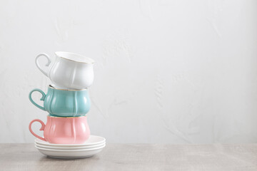 group of different cups on wooden table on white background