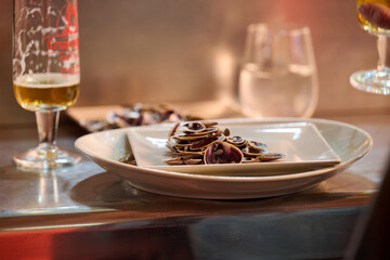 Plate of mussel shells and glass of beer