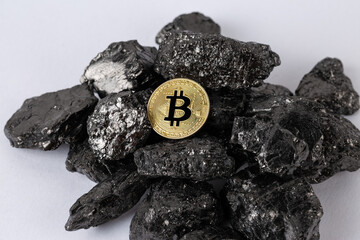 Mining bitcoin cryptocurrency on a pile of fossil fuels in the form of coal.