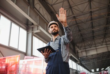 Factory technician working using digital tablet at factory warehouse