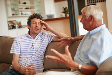 Dealing with disagreements. Shot of a man and his father having an argument.