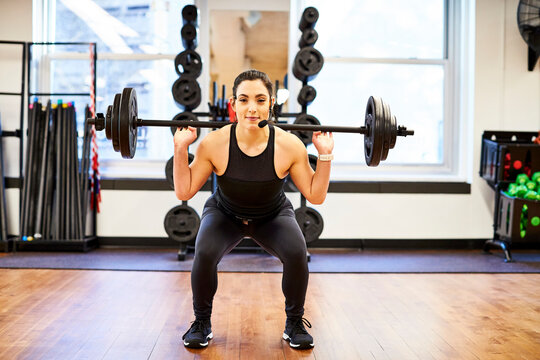 Fitness instructor lifting weights