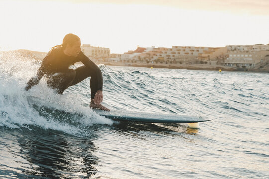 Surfer riding wave in sea