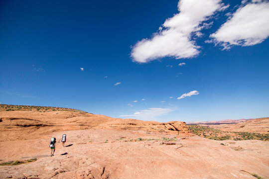 Two women hiking in desert, Grand&Acirc;&nbsp;Staircase-Escalante&Acirc;&nbsp;National Monument, Utah, USA