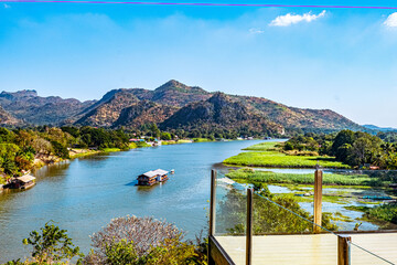 The beautiful landscape in the morning of the Kwai Noi River curve and the mountains
