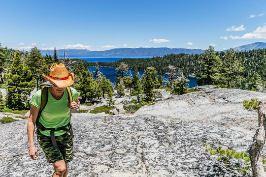 A female hiker moving cross country high above Cascade Lake and Lake Tahoe.