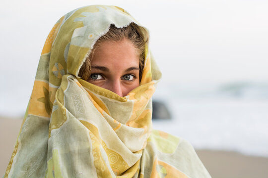 Young Woman With Blue Eyes Covering Up.