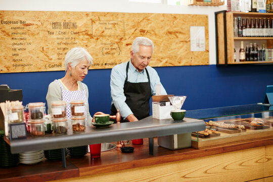 Support your local bakery. Shot of a senior couple running a small business together.
