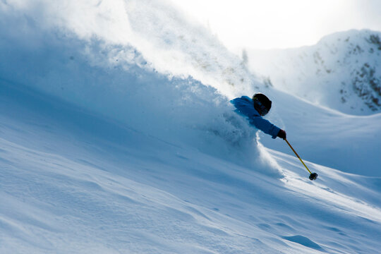 Young man skiing through deep snow, Brighton, Utah, USA