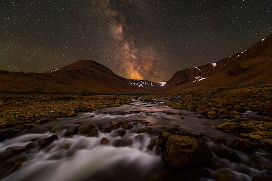 Milky Way above mountains and stream in Tablelands of Gros Morne National Park