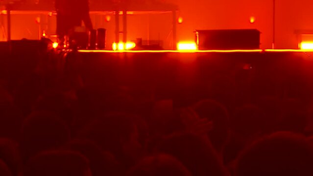 a large crowd of spectators at a rock concert in Moscow shoots a B-2 concert on smartphones and welcomes the musicians