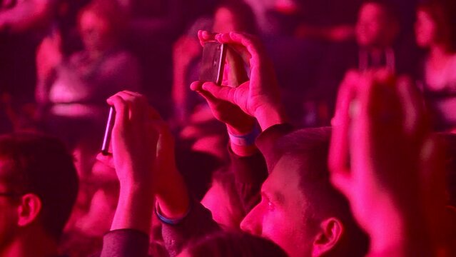 a large crowd of spectators at a rock concert in Moscow shoots a B-2 concert on smartphones and welcomes the musicians