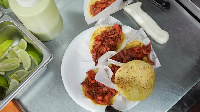 Filling soft taco shells with pulled pork - food truck series