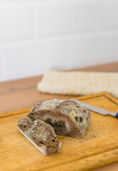 Close view of moldy bread and knife on a cutting board. Space for text. SDOF