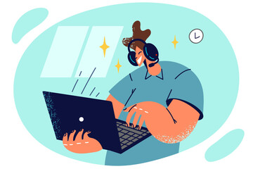 Man in headphones stands with laptop in hands and types or communicates via video call