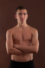 Fototapeta premium Handsome muscular shirtless adolescent boy flexing muscles.