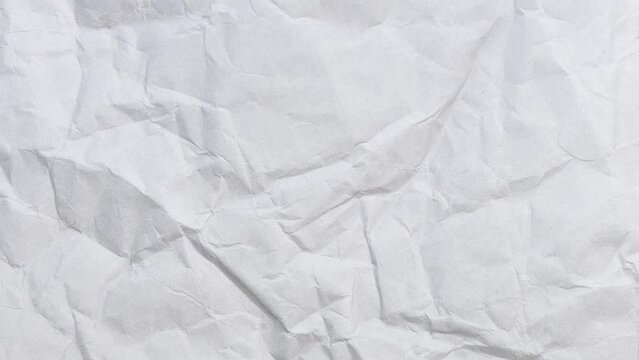 4K Crumpled Paper close-up animation on black background. folding open and closed top view modern design background