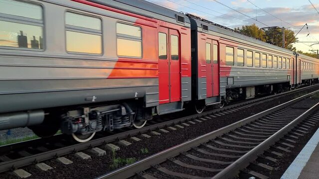Electric passenger train passing through railway track.