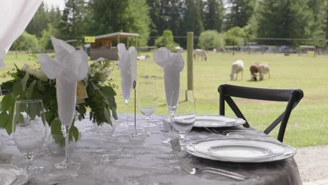 Banquet table for a wedding on a farm. The decoration is very elegant and everything looks carefully detailed.