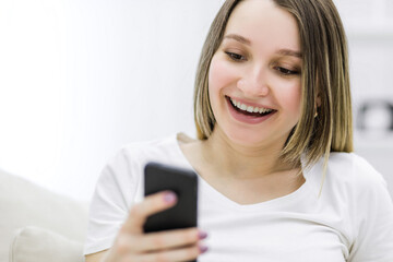 Close up photo of pregnant woman looking at the phone.