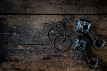 Piston and piston rod on dirty wood pattern.