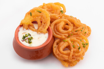 Indian Kesari Jalebi Also Called Jilapi, Jilebi, Jilipi, Zulbia, Jerry, Zalebi, Mushabak Topped With Creamy Lachhedar Malai Rabri Also Called Khurchan Rabdi, Lachha Rabidi Consumed On Diwali And Holi