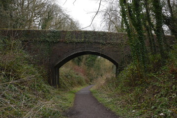 Fototapeta na wymiar a bridge crossing what used to be the railway at Ironbridge in Shropshire what is now a cycle path 
