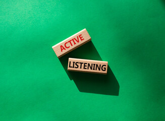 Active listening symbol. Wooden blocks with words Active listening. Beautiful green background. Business and Active listening concept. Copy space.