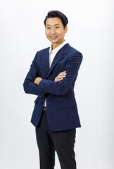 Obraz na płótnie Canvas Portrait isolated cutout studio shot Millennial Asian professional successful male businessman entrepreneur ceo manager in formal business suit stand smiling crossed arms posing on white background