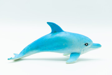 Miniature and game for children of a white and light blue dolphin on a white background.