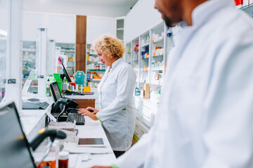 Pharmacist working at cash register.