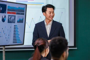 Millennial Asian professional successful male businessman presenter speaker lecturer in formal...