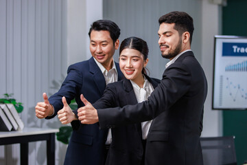 Millennial Asian  professional male businessmen female businesswomen employee staff colleagues in formal business suit sitting holding fists up celebrating job deal achievement