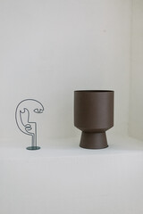 Brown vase on a white podium