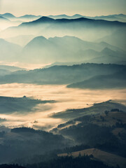 Mountain silhouettes in the fog. Graphic landscape on the theme of mountains