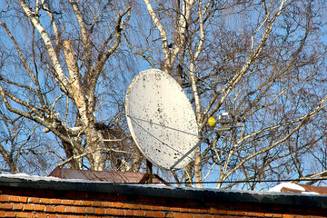 old satellite dish on the roof of the building