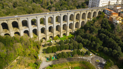 Aerial view of the monumental bridge and viaduct of Ariccia, Italy. It is a little city of Castelli Romani, in the metropolitan area of Rome. There are no cars on the road.