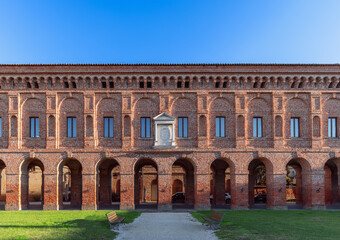 Beautiful red brick facade with columns and arches of Galleria degli Antichi in Sabbioneta city....