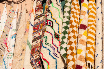 colored plush blankets in a shop in a souk in marrakech. 