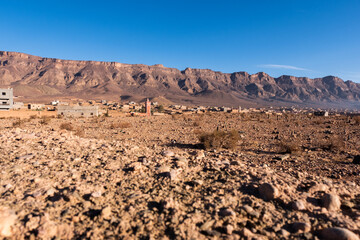 A barbaric village with a mosque in the middle of the morocco desert 