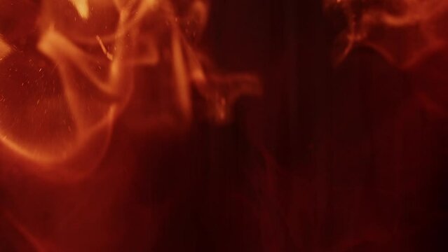 Macro shot of the beginning of a fire filmed in slow-motion. Mesmerizing forms and shape of the vibrant flames.
