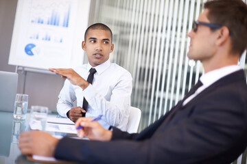 Voicing his opinions. Shot of a businessman explaining a concept to his colleague during a meeting.