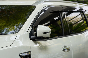 Fototapeta premium Side view door mirror of brand new white car.