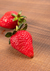 Fresh and Juicy beautiful organic strawberries on wooden background. Top view point.