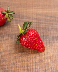 Fresh and Juicy beautiful organic strawberries on wooden background. Top view point.